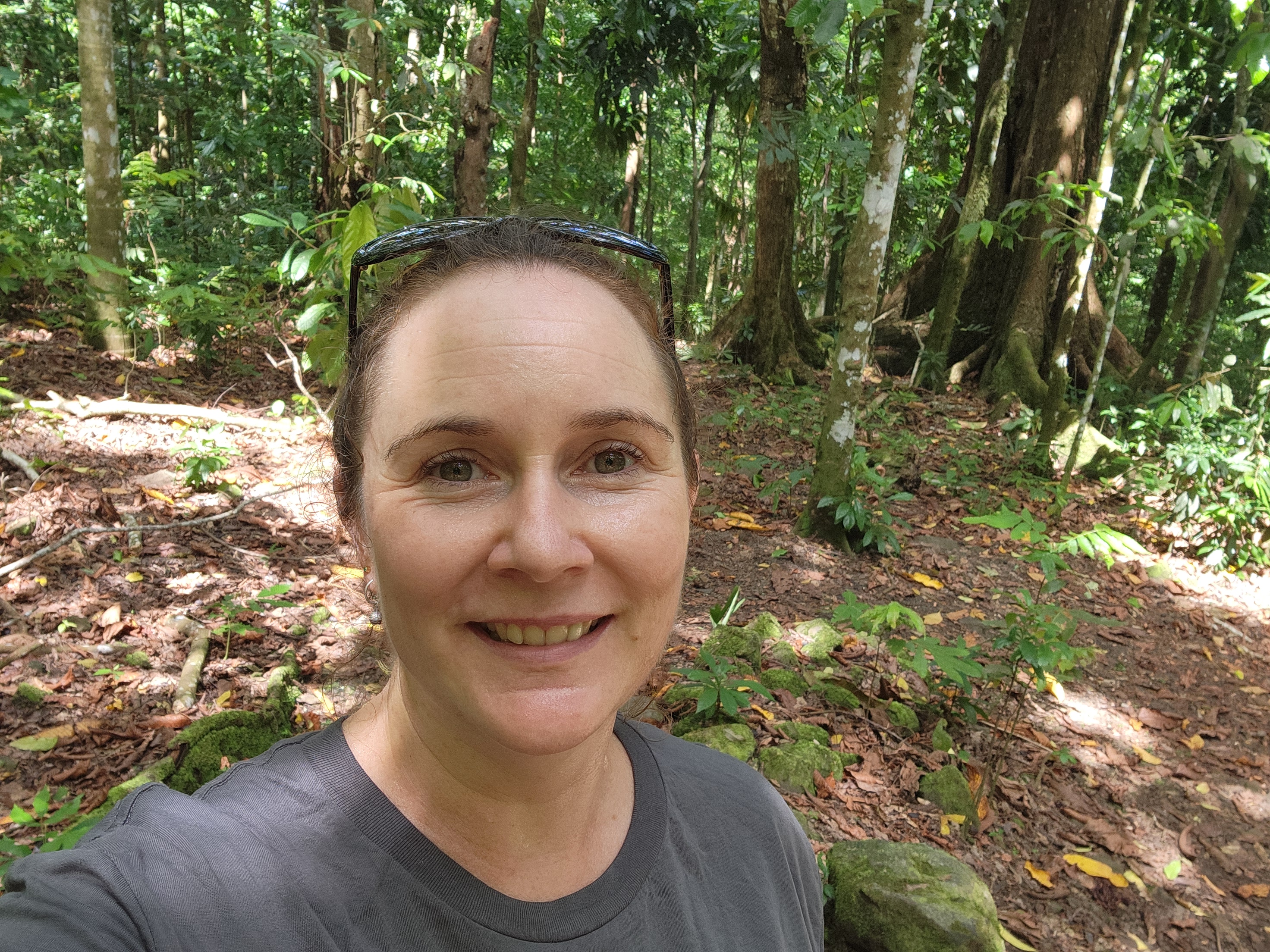Shelomi Doyle is smiling in a forest